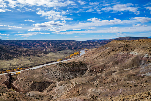 View from summit of McInnis Canyons in Utah with blue sky and clouds.