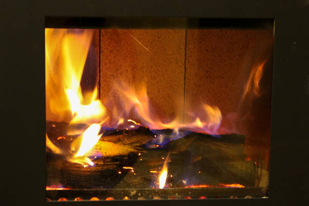 istock Fire behind the glass in a closed fireplace 1088523050