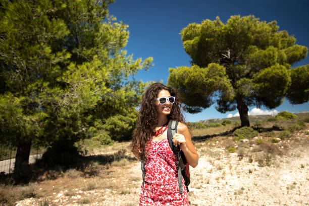 Beautiful woman hiking in nature, enjoying summer vacations.
