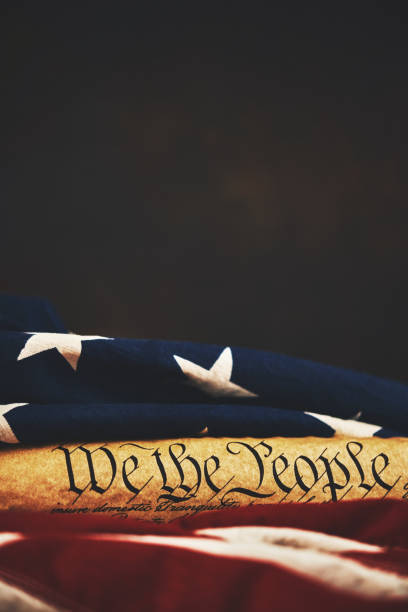 istock United States Constitution with American Flag 1088551494
