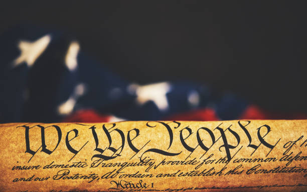 istock United States Constitution with American Flag 1088551502