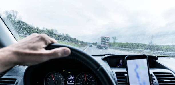 istock Car Driver Hand on Steering Wheel on Rainy Expressway Journey 1088552492