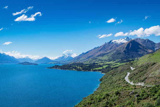 Bennetts Bluff Glenorchy Lake Wakatipu Mount Creighton New Zealand Beautiful Bennetts Bluff, Road from Queenstown to Glenorchy with Lake Wakatipu and Mount Creighton on a sunny Summer day. Lake Wakatipu,Queenstown to Glenorchy, Otago, South Island, New Zealand, Oceania. creighton stock pictures, royalty-free photos & images