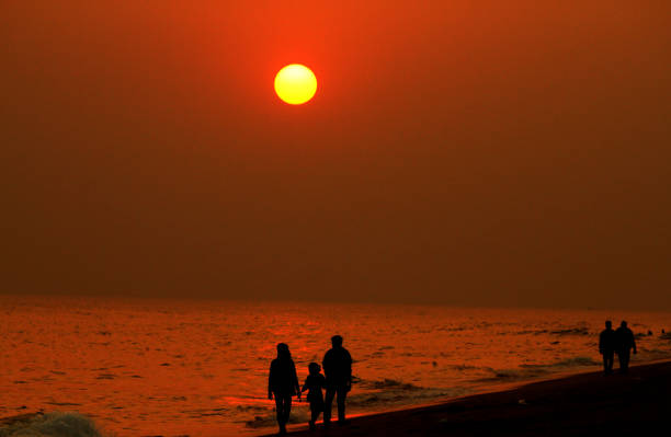 Visitors are seen at the Bay of Bengal Sea's eastern coast beach at Puri as 2018's last Sun sets on its horizon on the eve of New Year 2019, 65 km away from the eastern Indian state Odisha's capital city Bhubaneswar.
