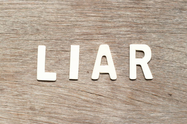 istock Alphabet letter in word liar on wood background 1088591400