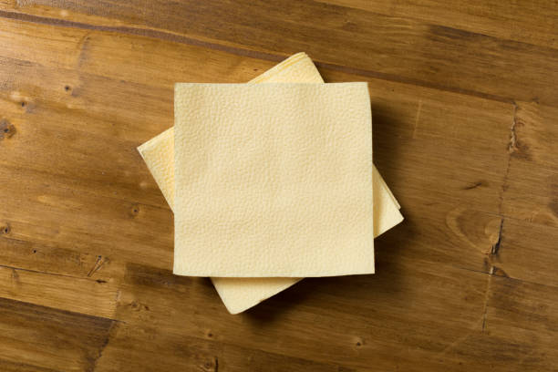 istock yellow paper napkin on wooden background 1088599714