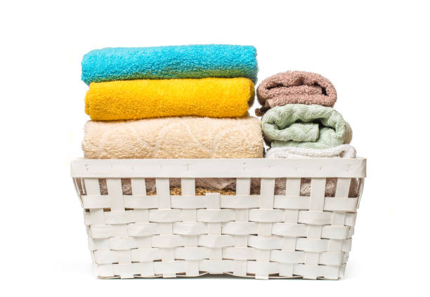 istock Clothes in a laundry wooden basket isolated on white background 1088601982