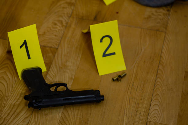 istock Bullets and gun at crime scene 1088620272