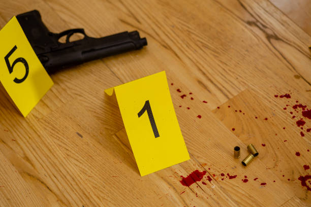 istock Bullets and gun at crime scene 1088621694