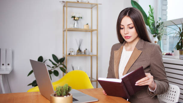 istock stylish business brunette works at a laptop. 1088635176