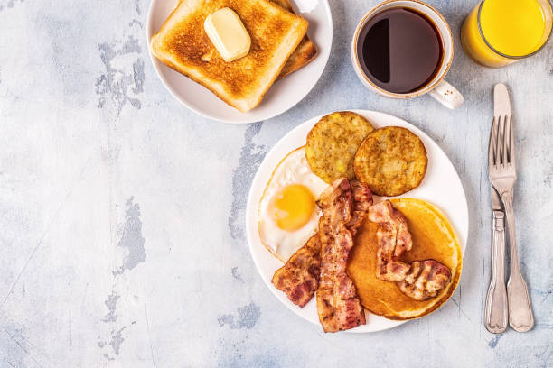 istock Healthy Full American Breakfast with Eggs Bacon Pancakes and Latkes 1088636972