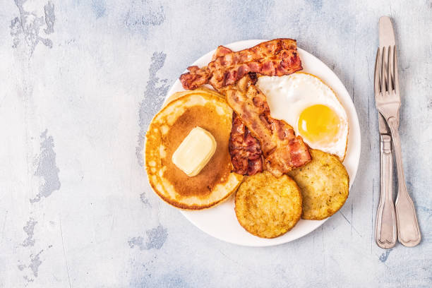 istock Healthy Full American Breakfast with Eggs Bacon Pancakes and Latkes 1088636976