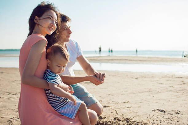 istock Cheerful multi ethnic family have a rest on a sea shore. 1088640942