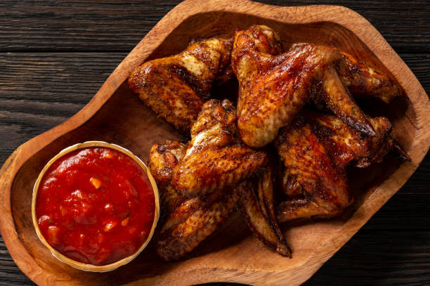istock Oven roasted chicken wings with tomato dip. 1088644920