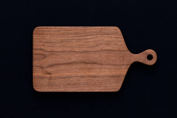 istock Handmade walnut chopping board on black cotton 1088646606