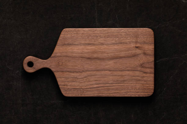 istock Handmade walnut chopping board on handmade tie dyed burlap 1088646794