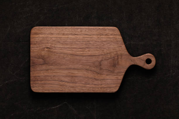 istock Handmade walnut chopping board on handmade tie dyed burlap 1088647108