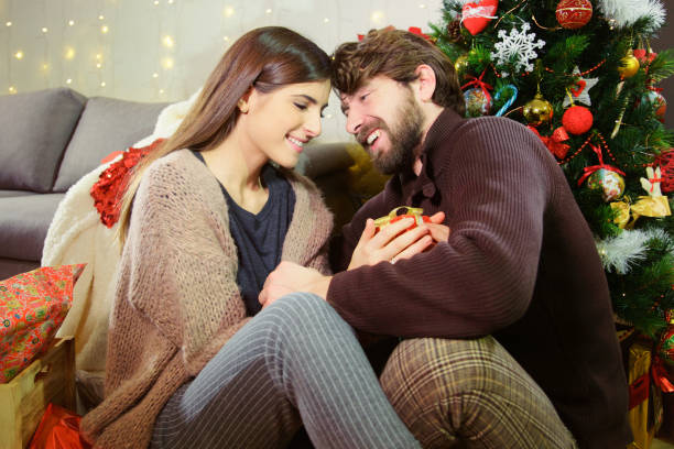 istock Happy couple having a good time in front of Christmas tree 1088649680
