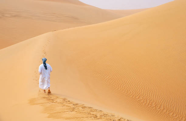 istock arab man walking in a desert 1088656226