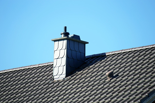 New tiled roof with slate cladded chimney
