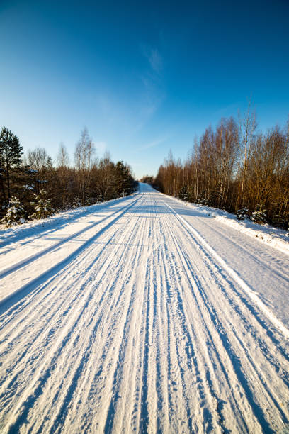 istock snow covered winter road with tire tracks 1088663492