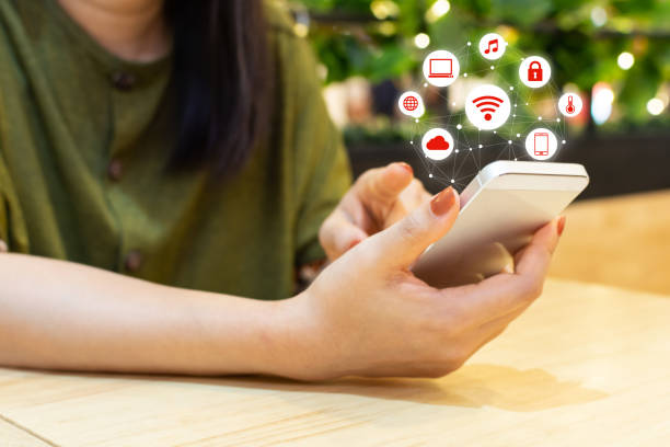 istock Asian woman hand using smartphone with icon technology communication and internet of things (IOT). Innovative convenience smart life concept 1088666906