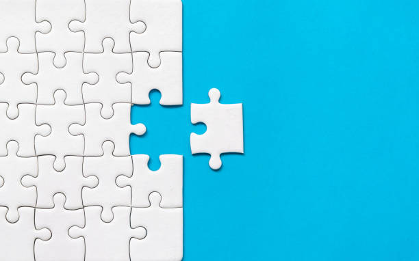 istock White jigsaw puzzle on blue background. Team business success partnership or teamwork. 1088666920