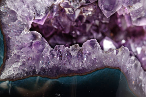 istock Macro Mineral Stone Amethysts in the rock on a white background 1088666930