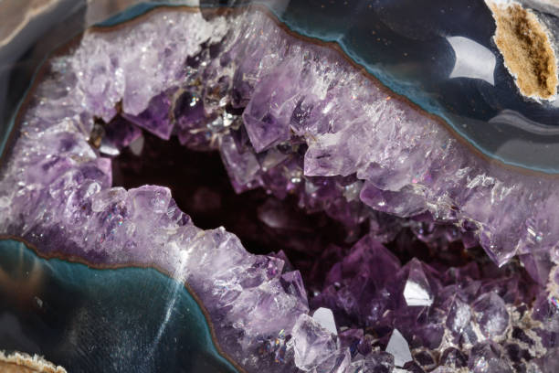 istock Macro Mineral Stone Amethysts in the rock on a white background 1088666972