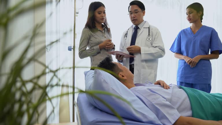 Dolly shot: Doctor explaining treatment method to senior patient and his relative