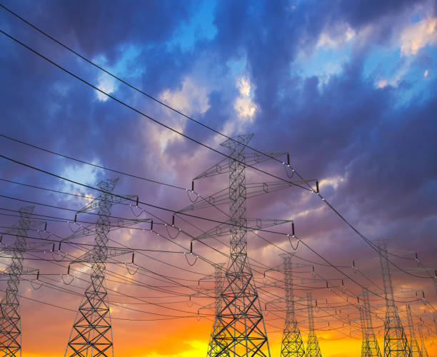 istock Electric Power Lines and Transmission Tower, Electric grid at sunset 1088679376
