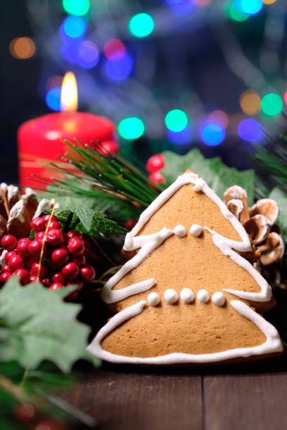 istock ginger biscuit  on brown background with Christmas tree ,  candles and christmas lights 1088681016