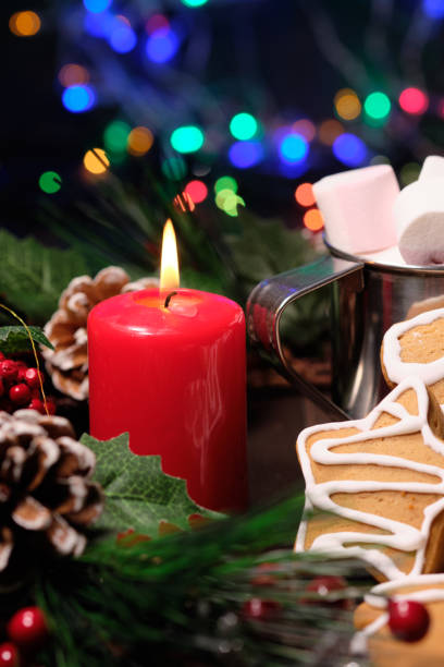 istock ginger biscuit and marshmallow on brown background with Christmas tree ,  candles and christmas lights. 1088681698