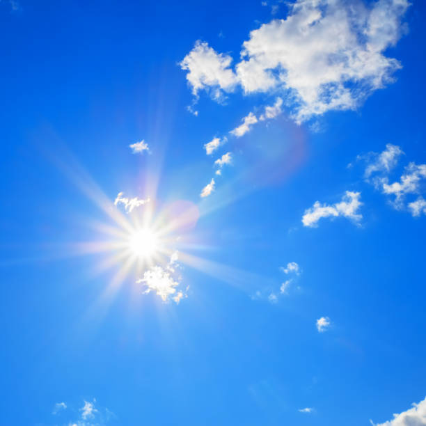 istock Sun with beautiful beams in the blue sky with some clouds 1088681772