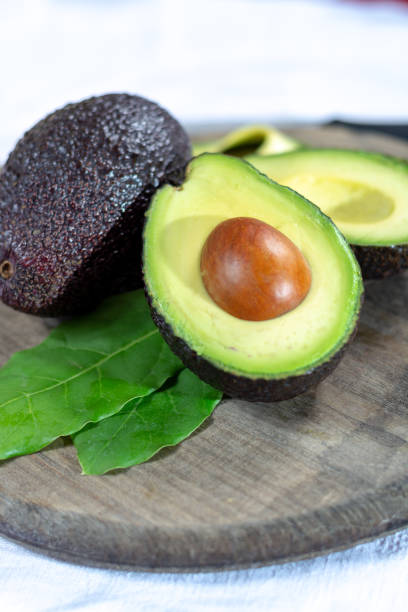 istock Two ripe raw hass avocados close up 1088688544