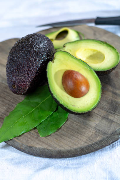 istock Two ripe raw hass avocados close up 1088688548