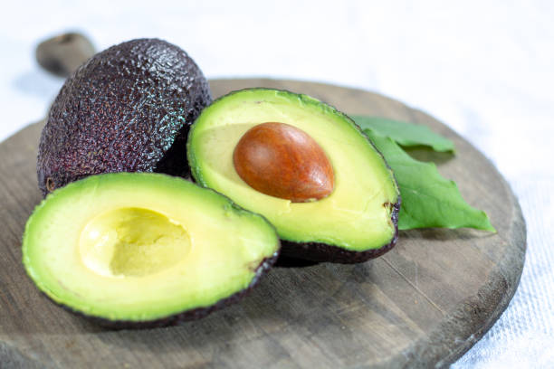 istock Two ripe raw hass avocados close up 1088688562