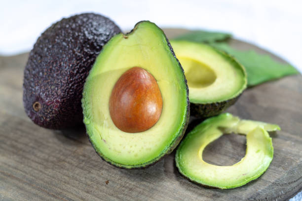 istock Two ripe raw hass avocados close up 1088688600