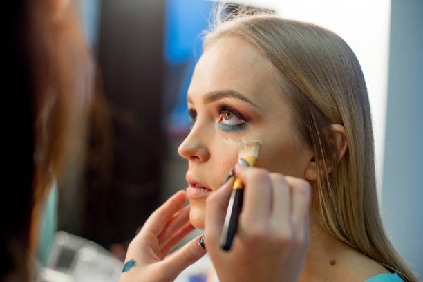 istock Professional makeup artist working on young girl 1088693324