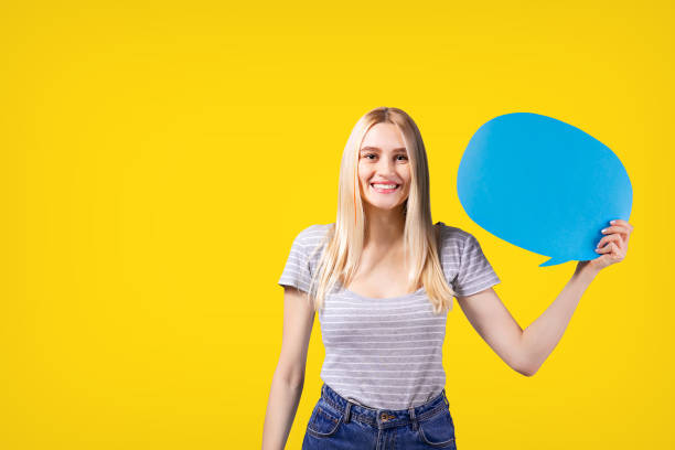 istock Young female model with long blonde hair holding text bubble. 1088698646
