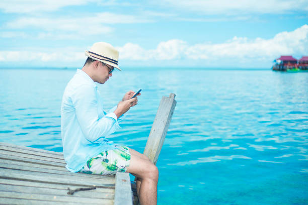 istock a handsome man sit and enjoy on the derawan island, borneo, Indonesia 1088701244