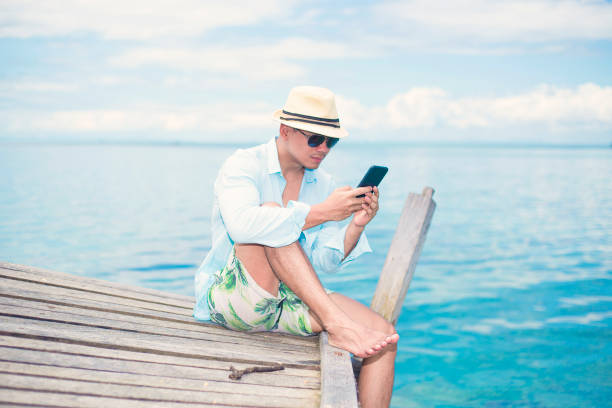 istock a handsome man sit and enjoy on the derawan island, borneo, Indonesia 1088701318