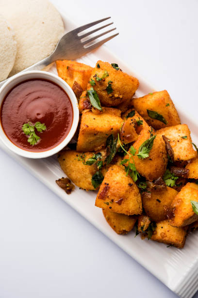 istock Masala fried Idlies - south indian Snack made using with leftover idly served with tomato ketchup. selective focus 1088702810