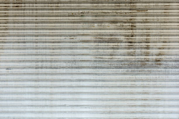 Old grunge and rusty steel rolling door background and texture.
