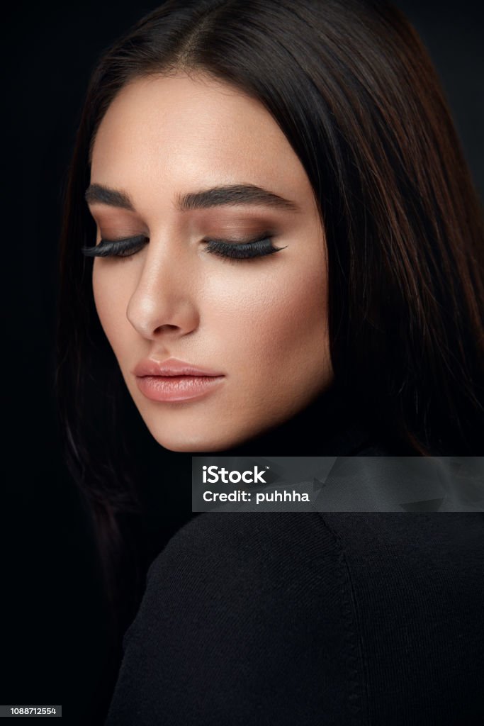 Eyelashes Makeup. Woman Beauty Face With Black Lashes Extensions Eyelashes Makeup. Woman Beauty Face With Long Black Lashes Extensions And Beautiful Makeup On Black. High Resolution Eyebrow Stock Photo