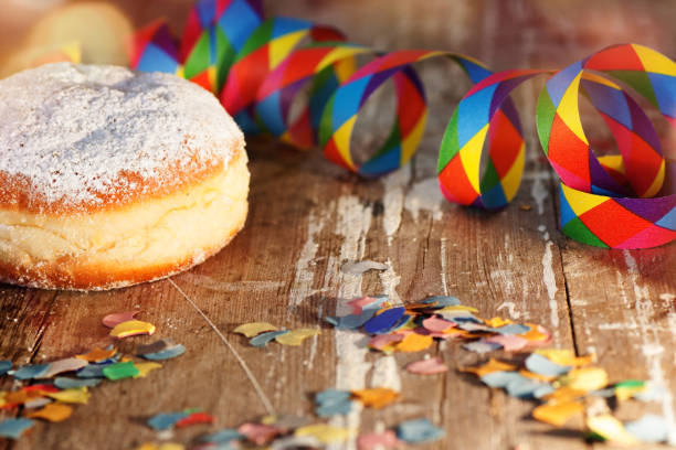 German Krapfen or donuts with streamers and confetti. Traditional Berliner for carnival and party.