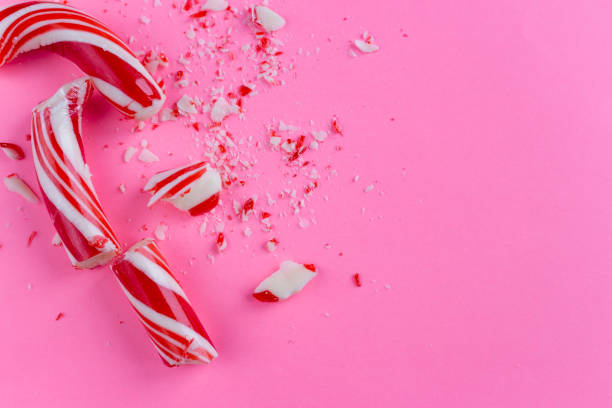 istock broken candy cane on pink background. close-up photo 1088729278