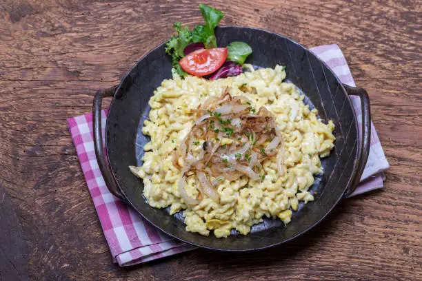 closeup of bavarian kaes spaetzle on wood