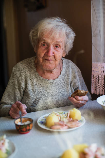 istock An elderly woman eats at home. 1088732248