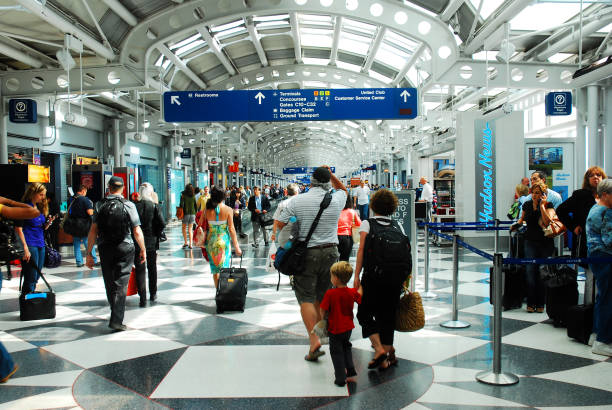Travelers rushing through the airport to make their flights stock photo